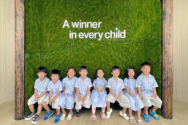 KiddiWinkie children at the tagline wall: A winner in every child